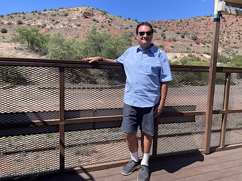 Enjoying the scenery and sun on an open-air viewing platform railway car