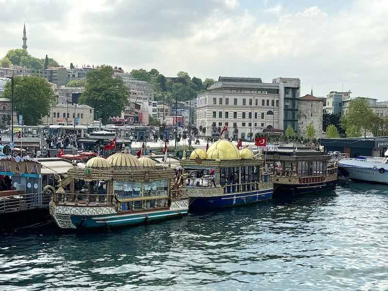 Three small boats offering Bal¹k ekmek sandwiches at the Golden Horn Bridge