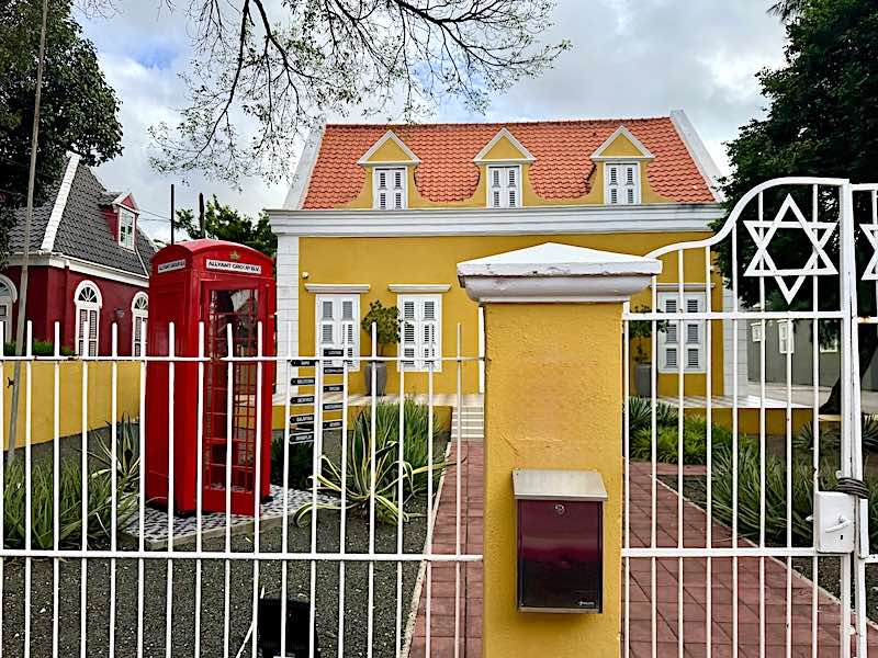 A brightly painted restored mansion along Scharlooweg street