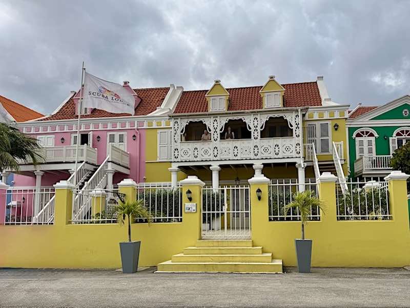 Brightly painted hotels along the waterfront on Kaya Wilson Godett Street